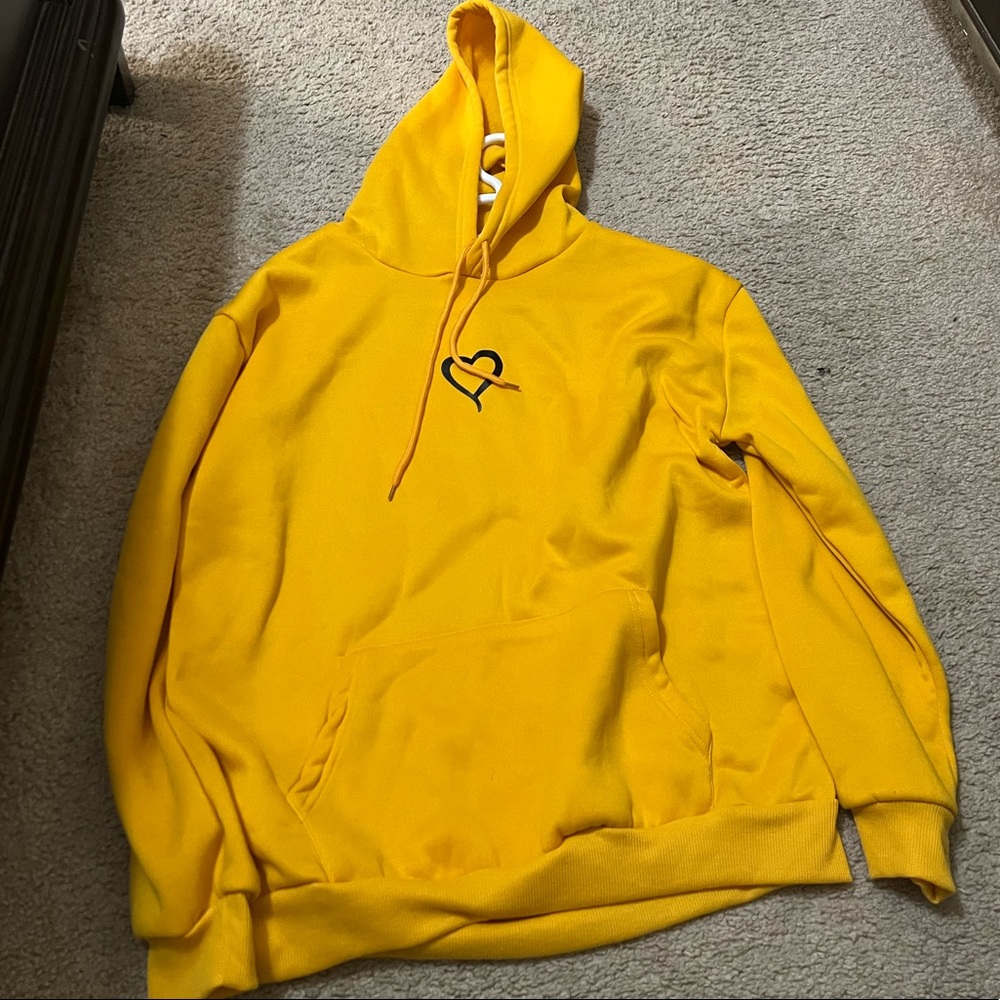 Yellow medium hoodie with a heart design very common never worn